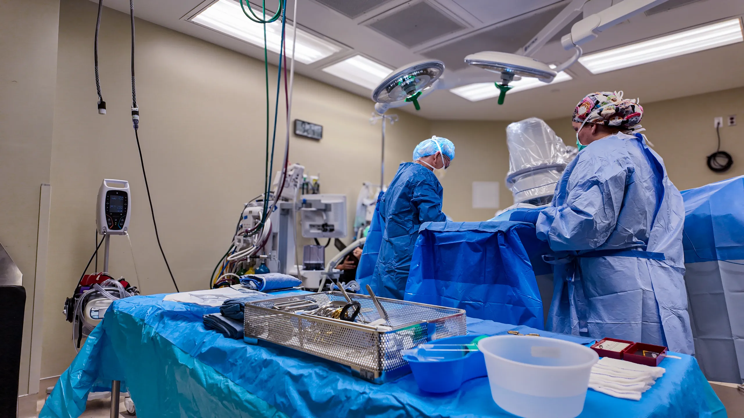 Surgical instruments laid out on a blue drape